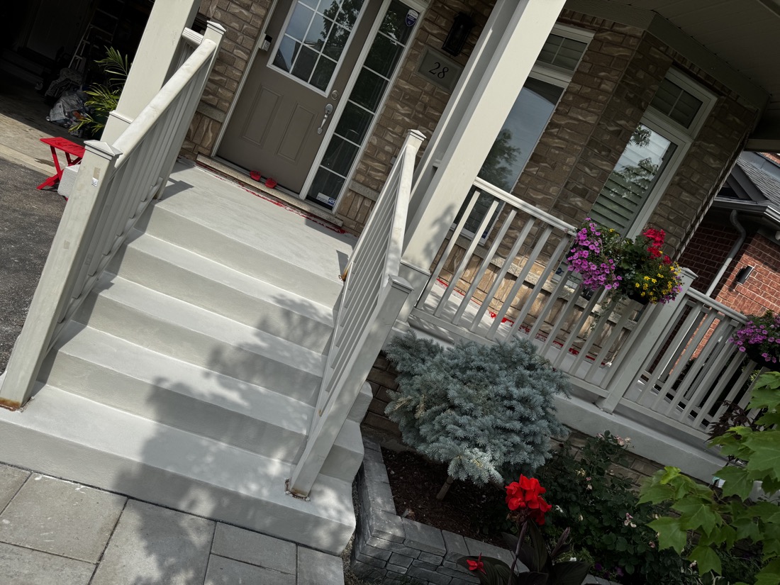 Freshly parged porch steps and railings finished with flowers out front at a Toronto home