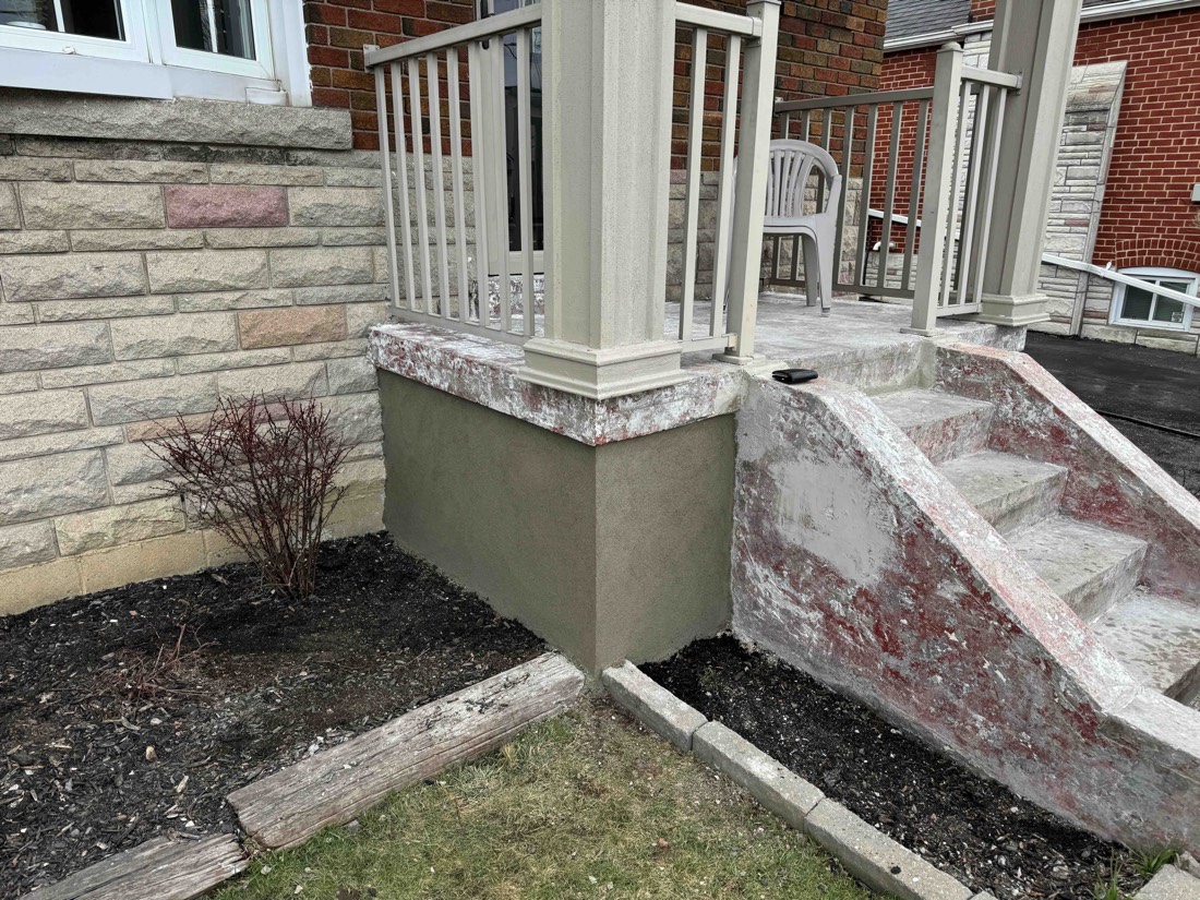 Freshly parged porch foundation with steps prepped for coating at a Hamilton home