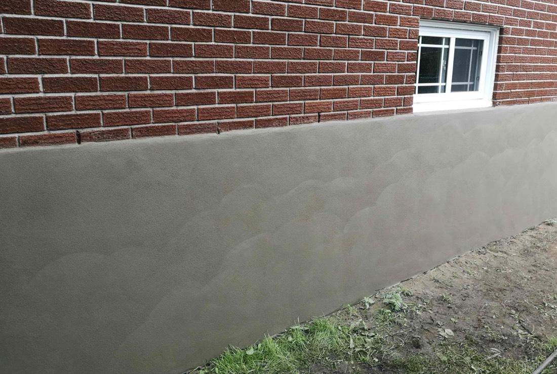 Close-up of a smooth parged foundation wall
